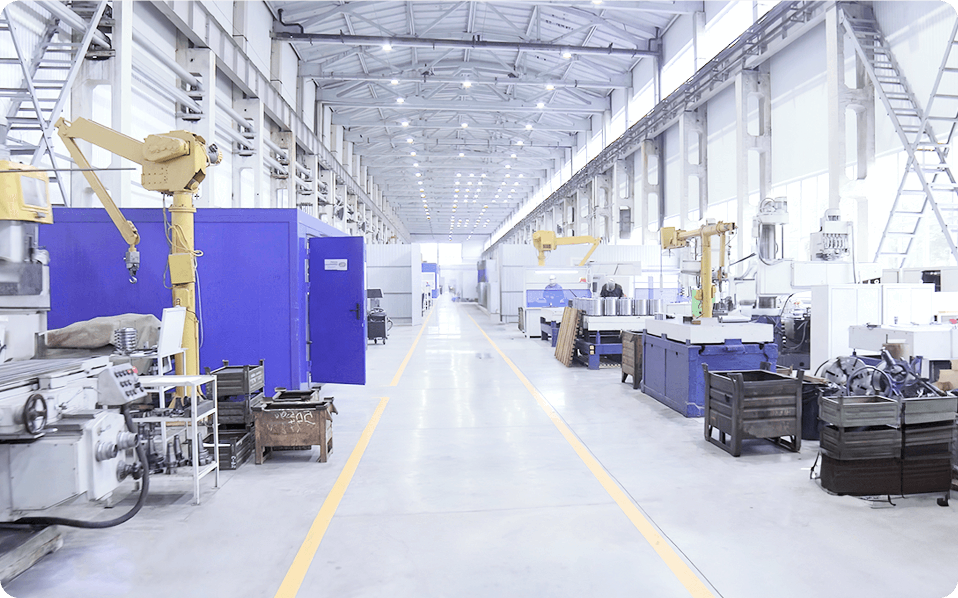 Modern manufacturing facility with robotic arms and industrial machinery.